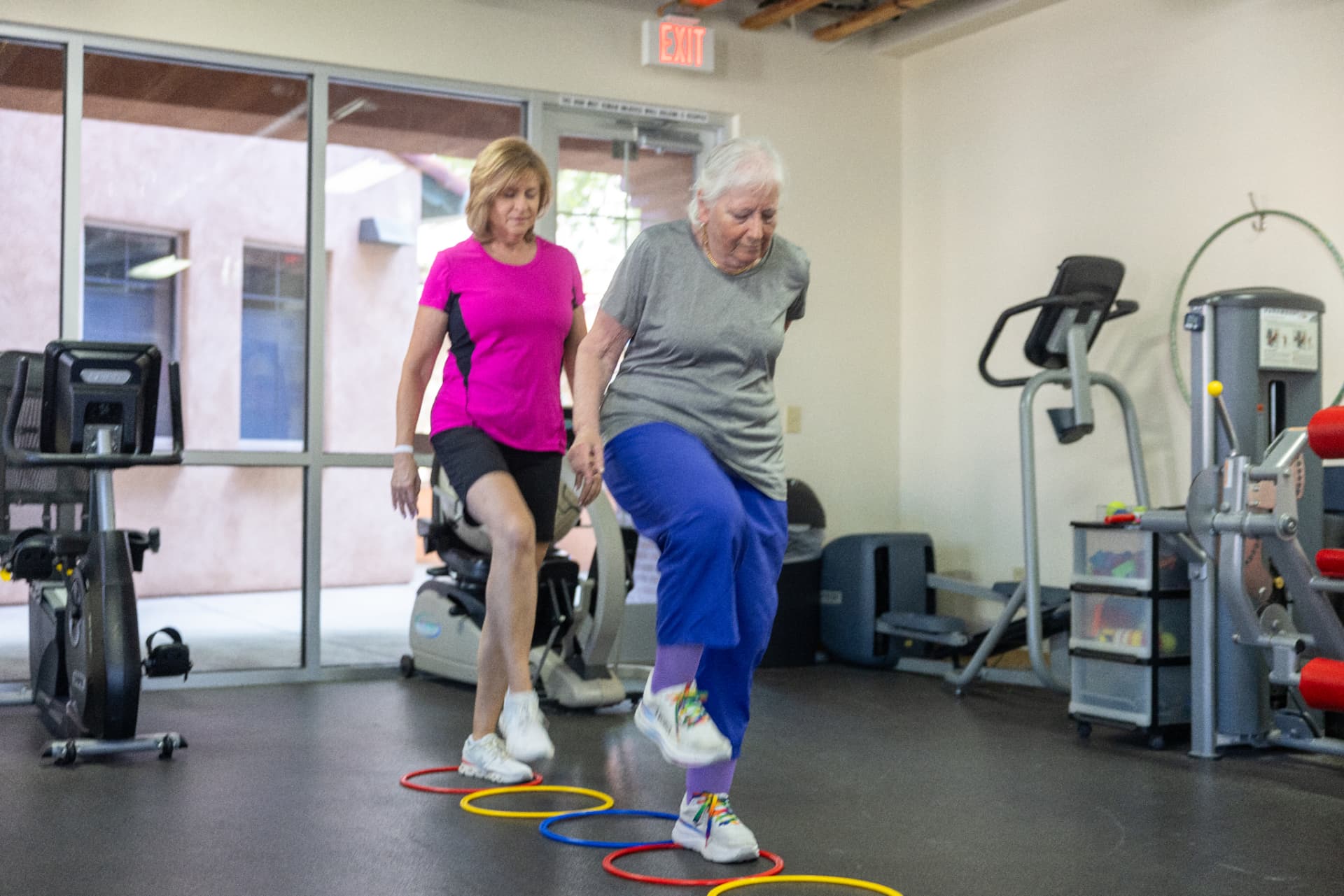 Coach guiding an older adult through balance training in Oro Valley, AZ